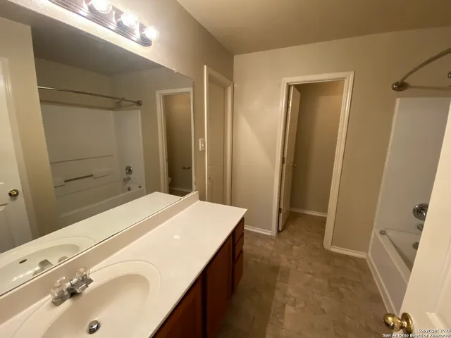 a bathroom with a sink a mirror and a shower