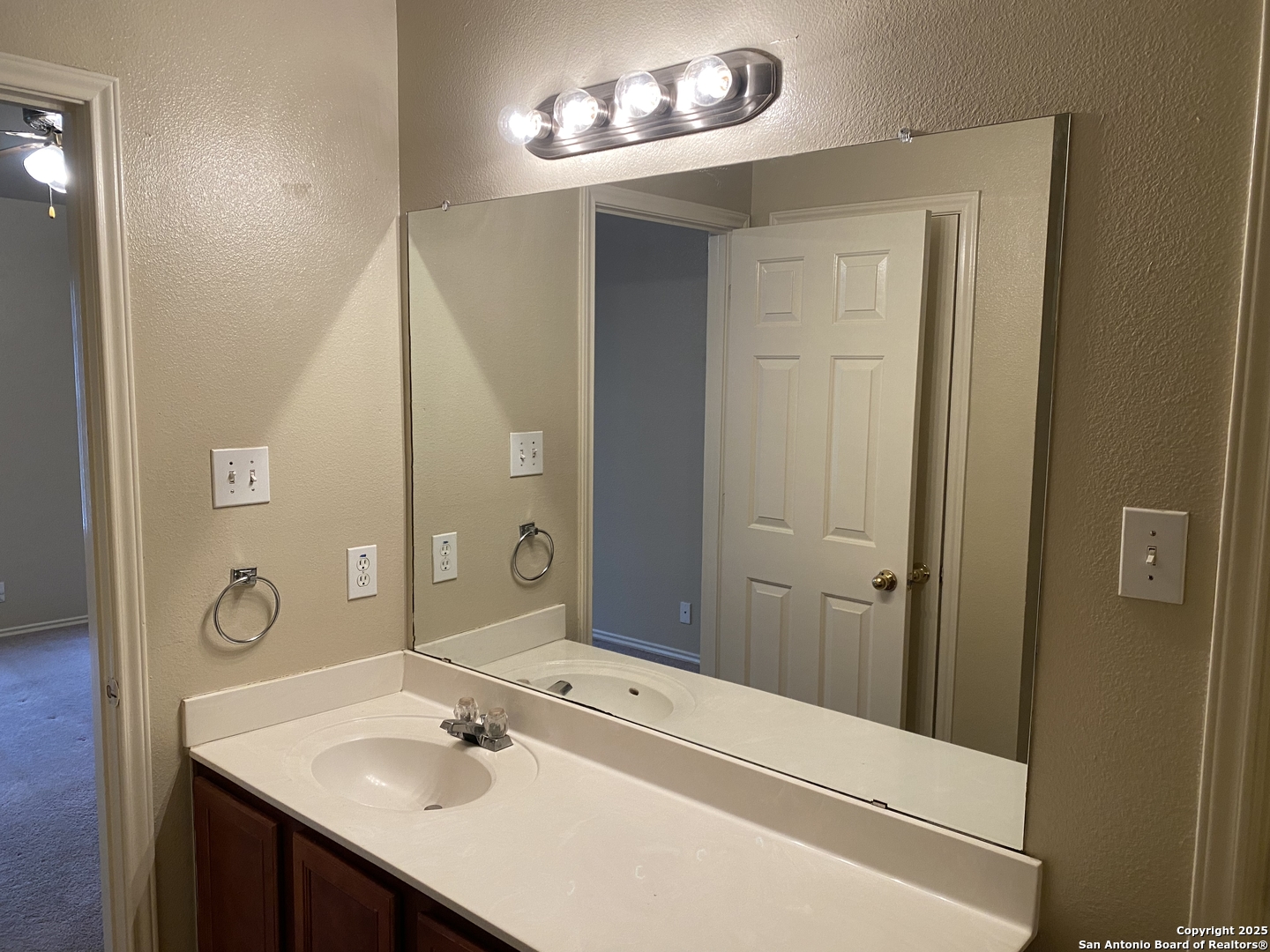 3338 Whisper Manor Schertz, TX 78108 - Photo 20 of 45 a bathroom with a sink a mirror and a shower