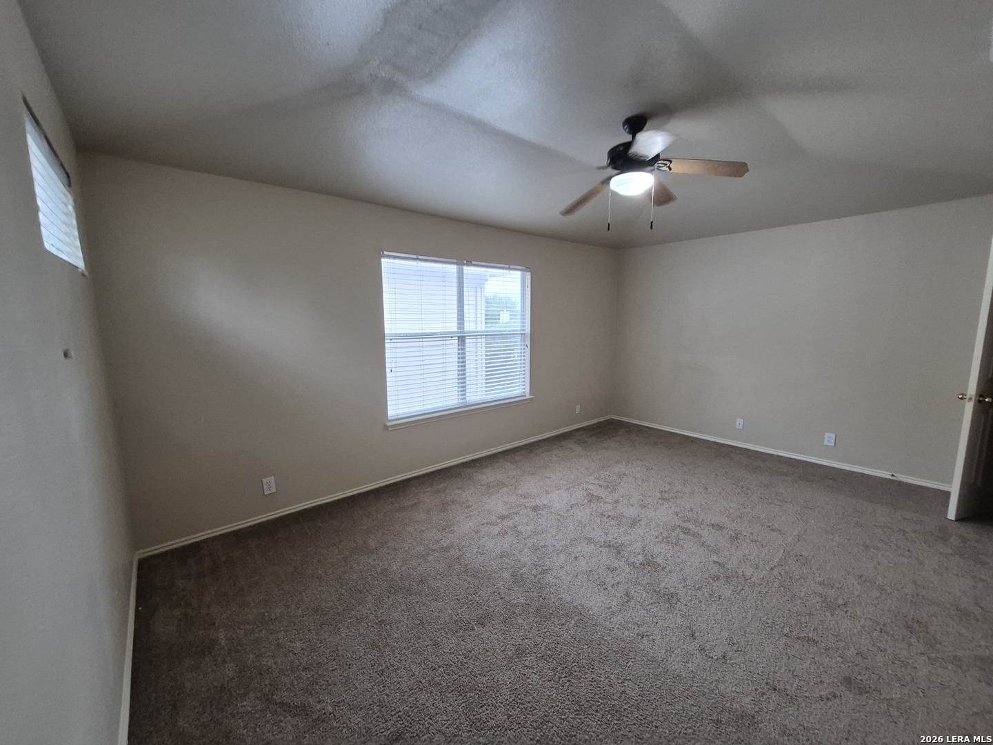 3338 Whisper Manor Schertz, TX 78108 - Photo 22 of 40 an empty room with windows and ceiling fan