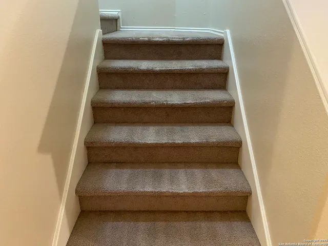 an empty room with a ceiling fan and a window