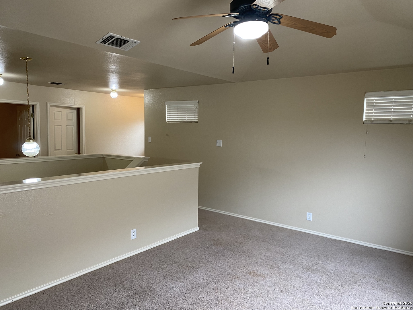3338 Whisper Manor Schertz, TX 78108 - Photo 26 of 45 an empty room with a chandelier fan and wooden floor
