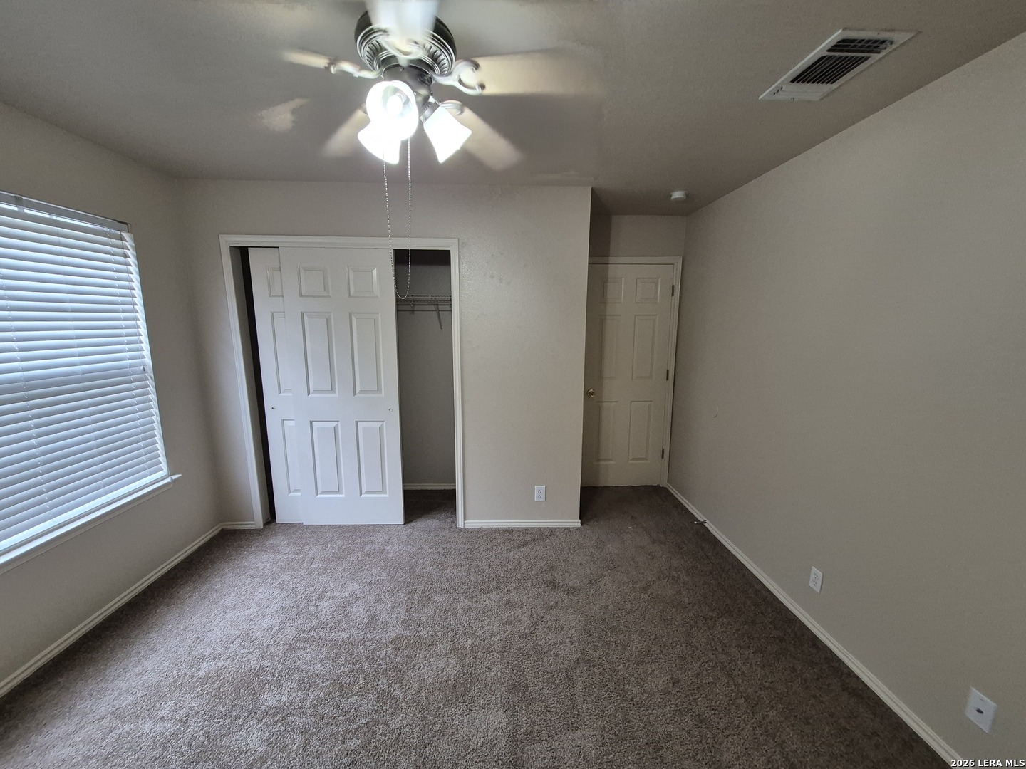 3338 Whisper Manor Schertz, TX 78108 - Photo 28 of 40 an empty room with a chandelier fan and windows