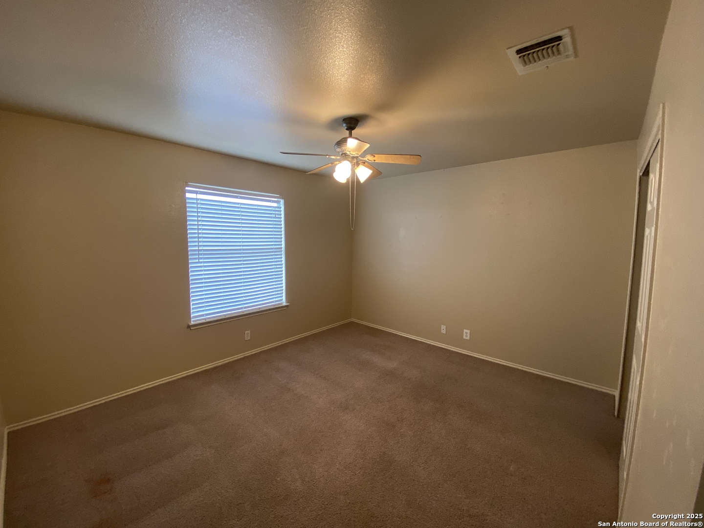 3338 Whisper Manor Schertz, TX 78108 - Photo 28 of 45 an empty room with a chandelier fan and windows