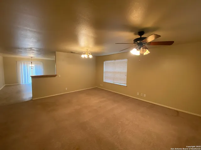 an empty room with a empty space and a ceiling fan