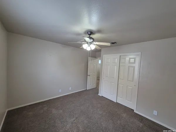 a view of a chandelier fan and entryway
