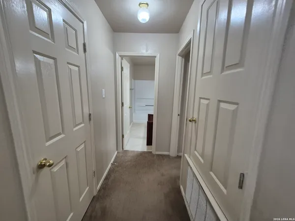 a view of a hallway with wooden floor and closet