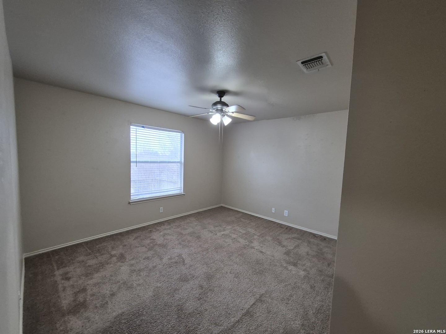 3338 Whisper Manor Schertz, TX 78108 - Photo 34 of 40 an empty room with a chandelier fan and windows