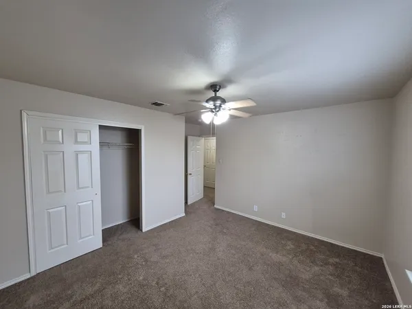 a view of an empty room with a fan