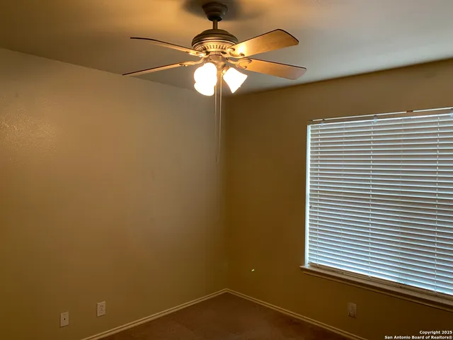 a view of a livingroom with a chandelier fan