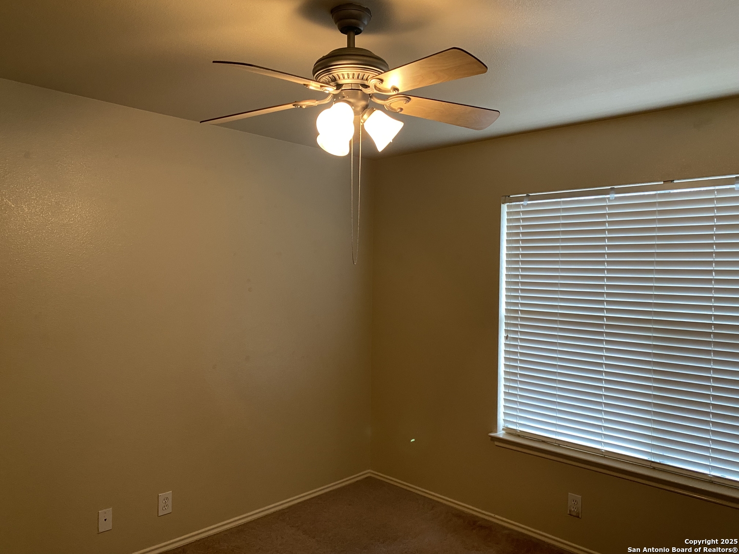 3338 Whisper Manor Schertz, TX 78108 - Photo 39 of 45 a view of a room with a chandelier fan and a window