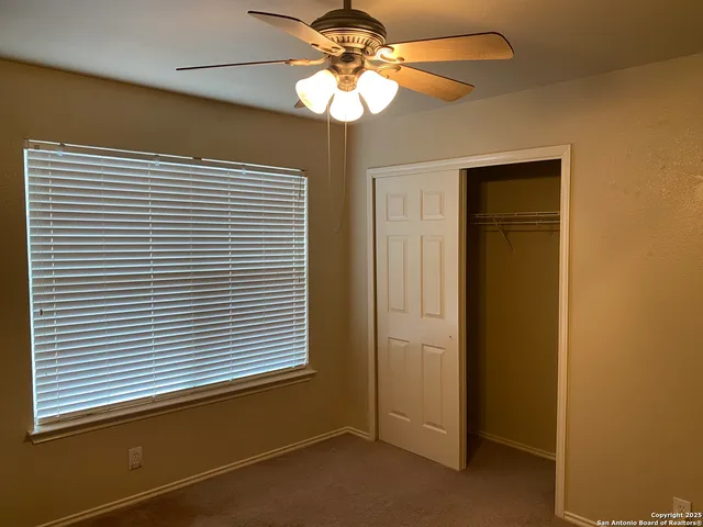 an empty room with a fan