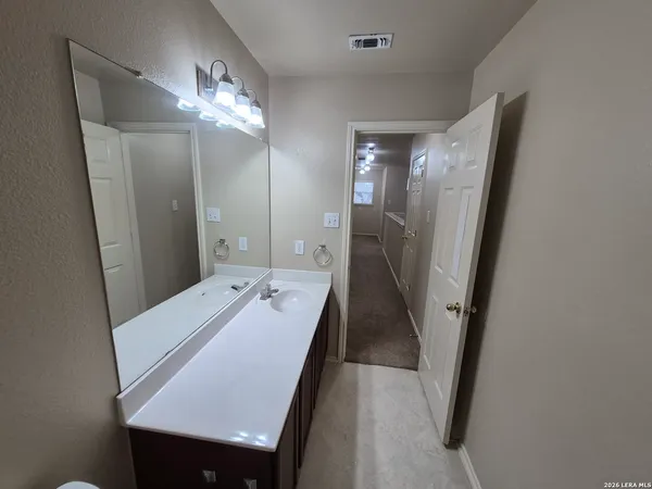 a bathroom with a sink a mirror and a shower