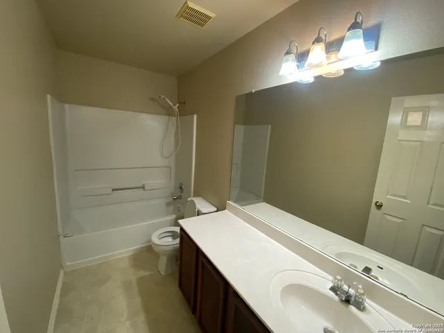 a bathroom with a shower and a toilet