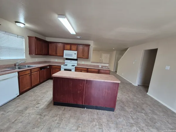 a kitchen with a sink stove and cabinets