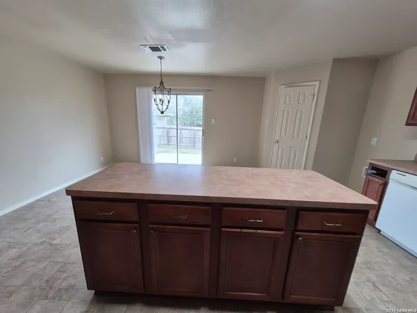 a room with a table chairs and wooden floor