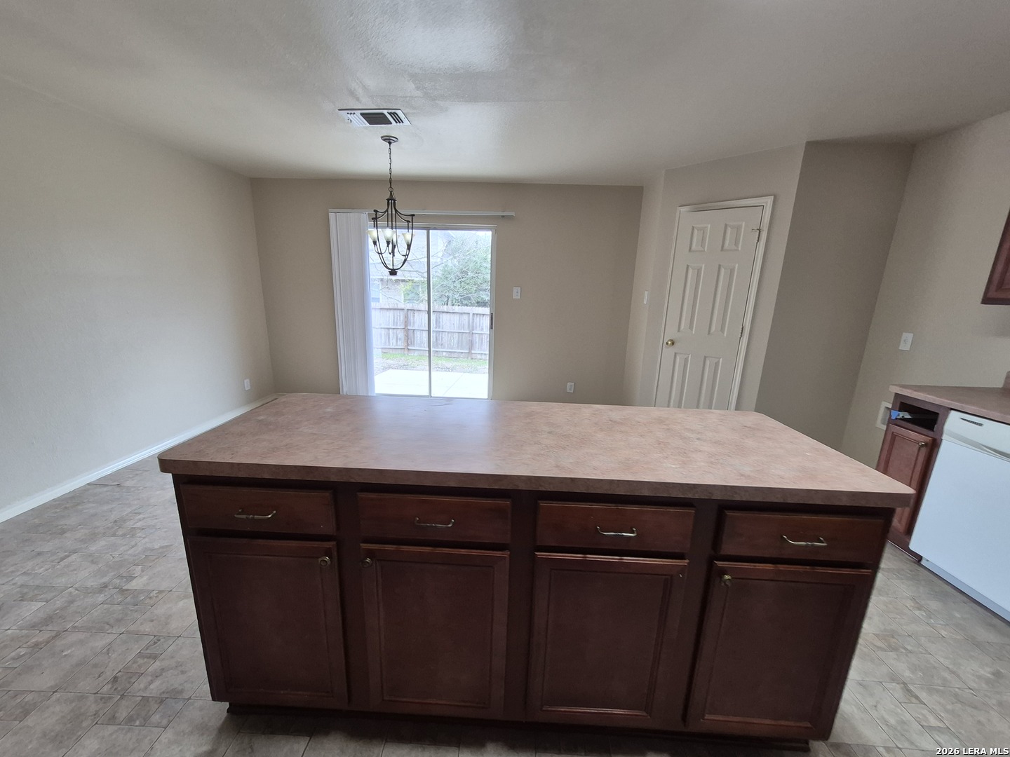 3338 Whisper Manor Schertz, TX 78108 - Photo 10 of 40 a room with a table chairs and wooden floor