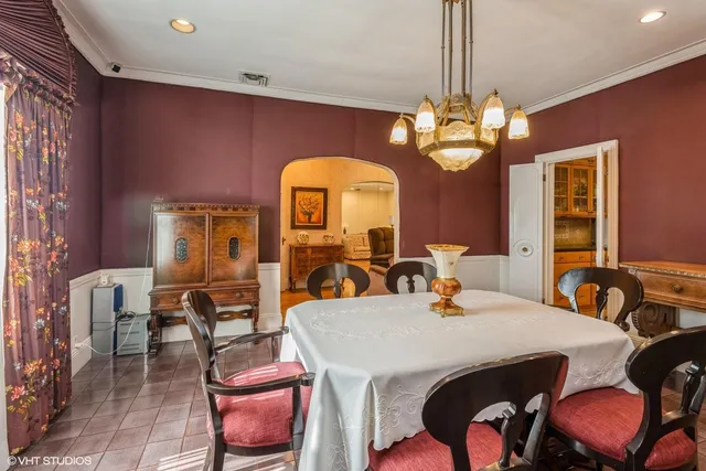 a view of a dining room with furniture and chandelier