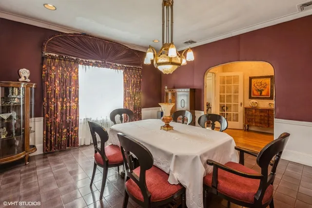 a view of a dining room with furniture and chandelier