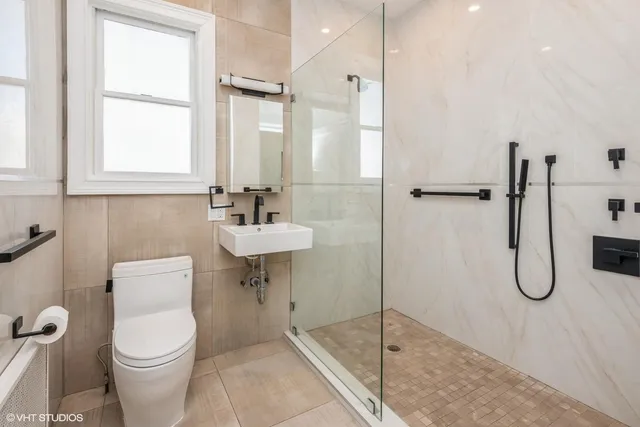 a bathroom with a toilet sink and shower