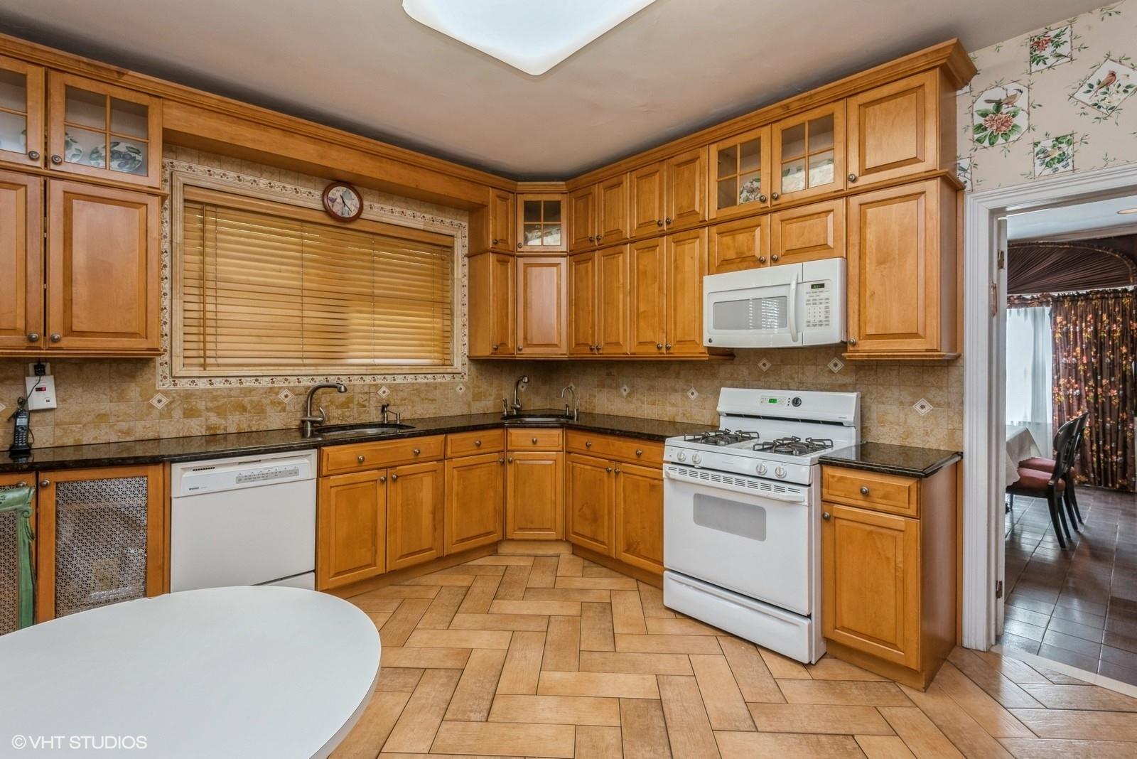 130 Hards Lane Lawrence, NY 11559 - Photo 18 of 36 a kitchen with stainless steel appliances granite countertop a stove a sink and a microwave