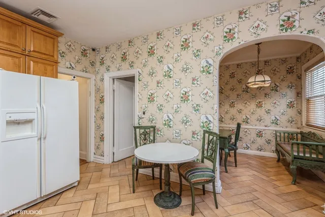 a bathroom with a sink a chair and a mirror