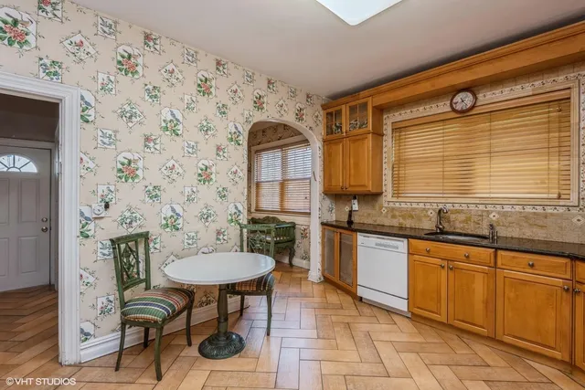 a kitchen with stainless steel appliances granite countertop a sink stove and cabinets