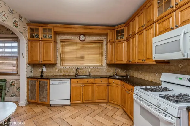 a bedroom with a bed lamp and a window