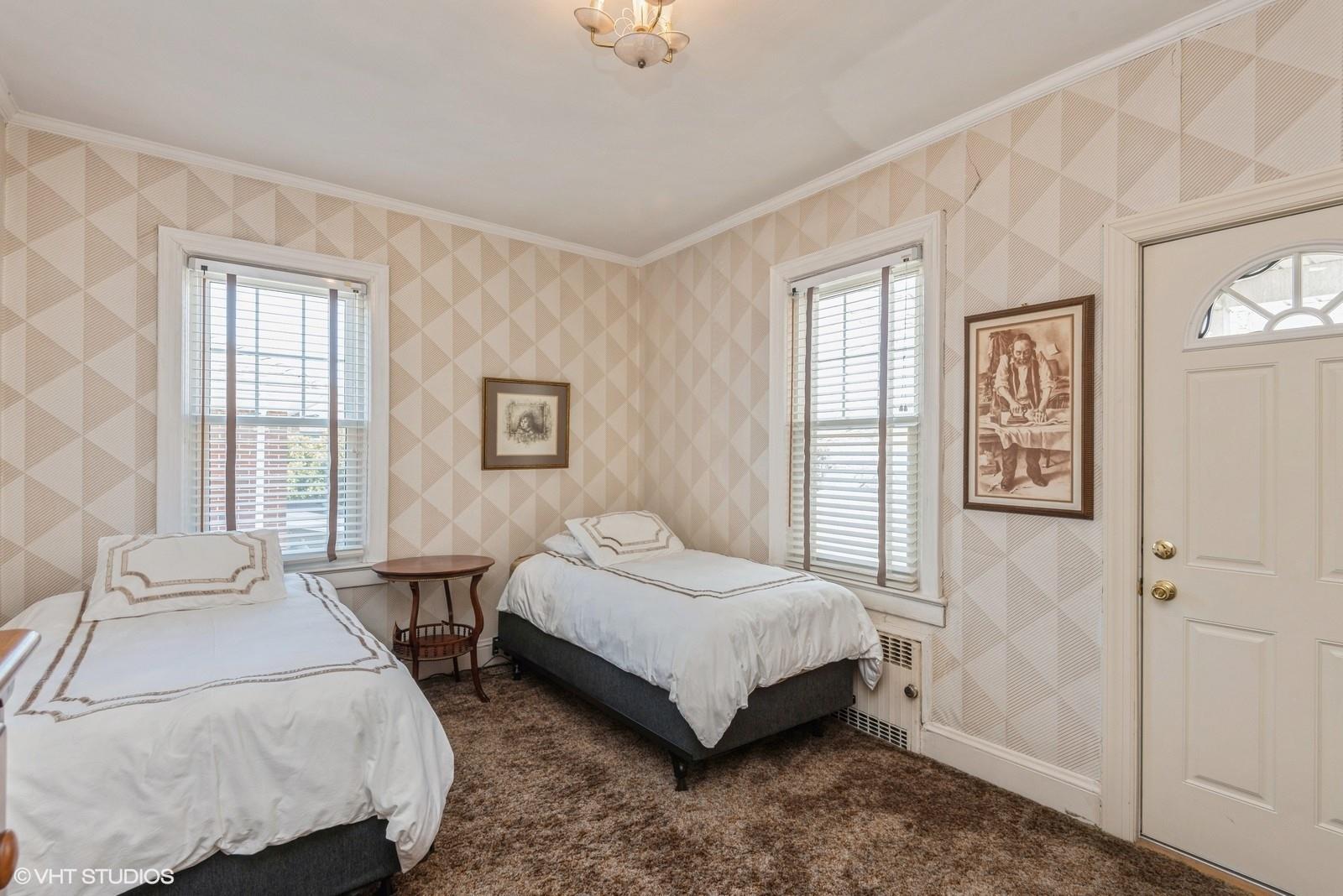 130 Hards Lane Lawrence, NY 11559 - Photo 24 of 36 a bedroom with a bed lamp and a window