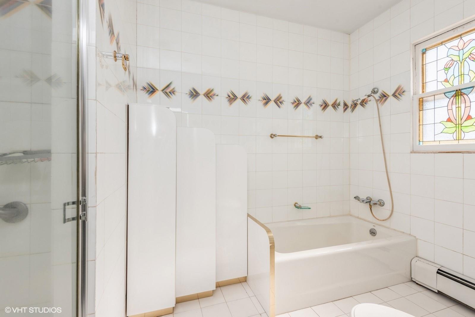 130 Hards Lane Lawrence, NY 11559 - Photo 27 of 36 a bathroom with a tub a window and a shower