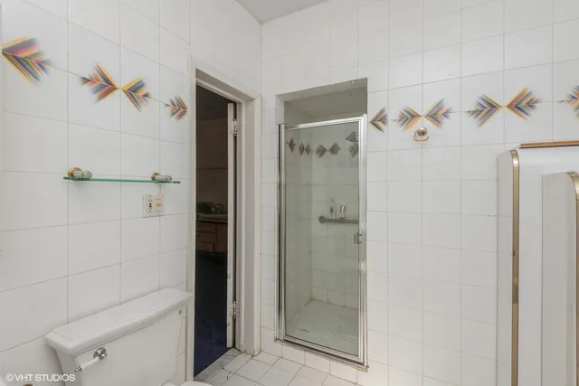 a bathroom with a sink a window and a shower