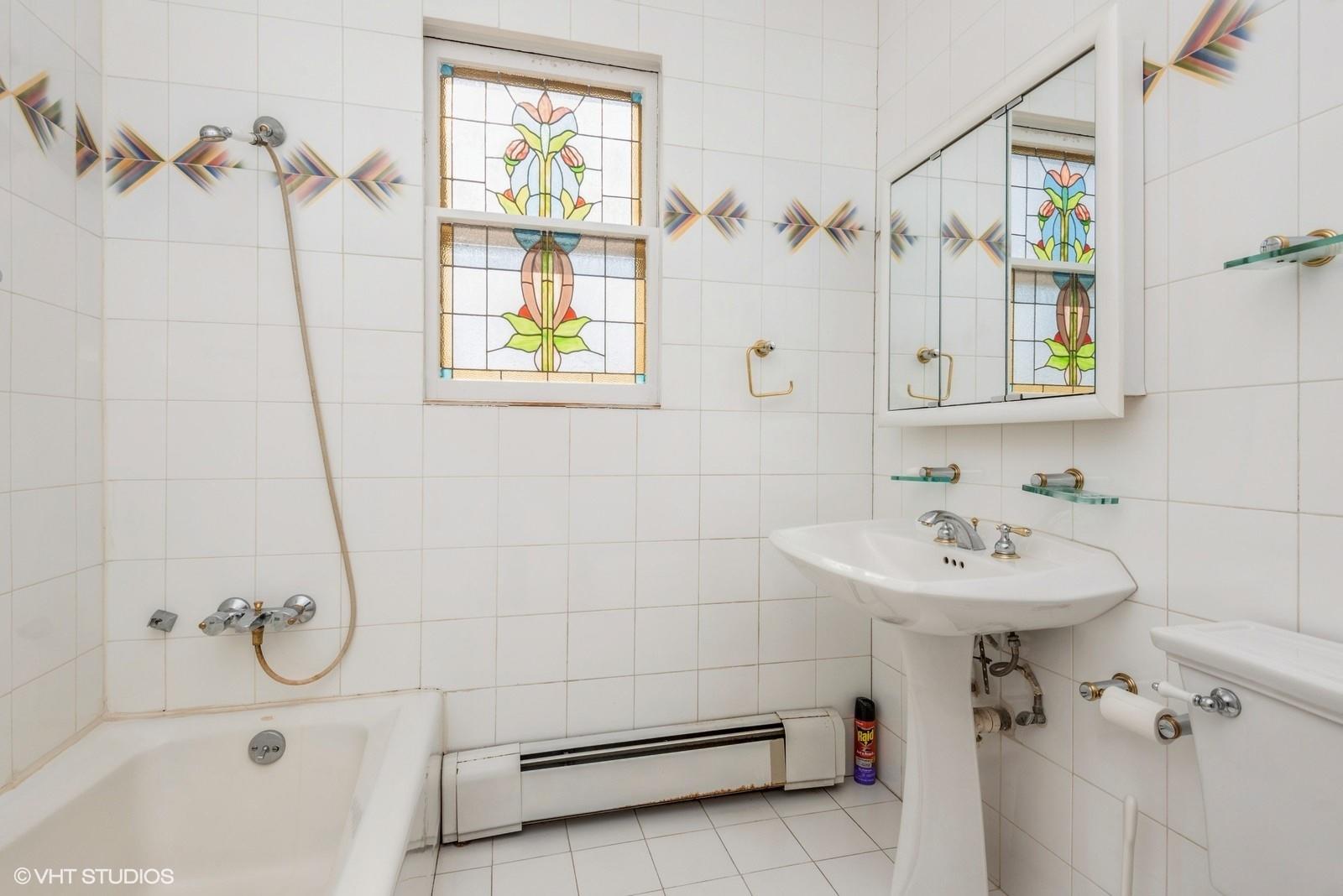 130 Hards Lane Lawrence, NY 11559 - Photo 29 of 36 a bathroom with a sink a window and a shower