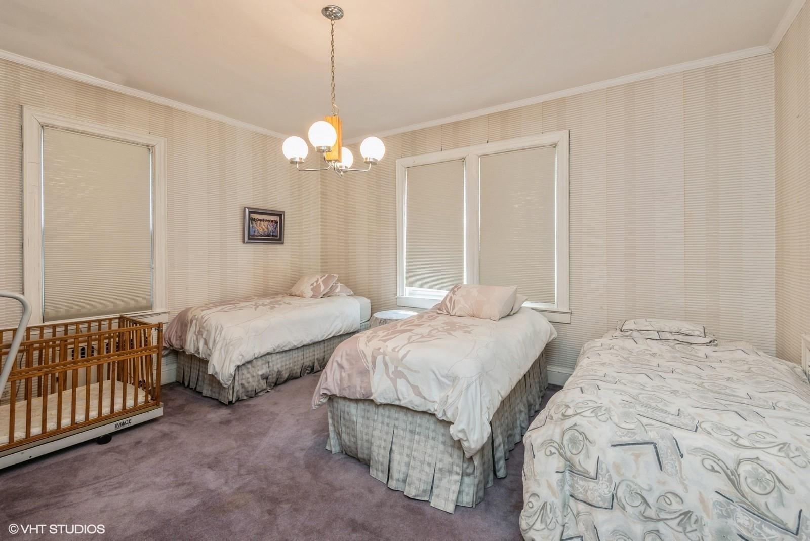 130 Hards Lane Lawrence, NY 11559 - Photo 32 of 36 a bedroom with two beds and a chandelier