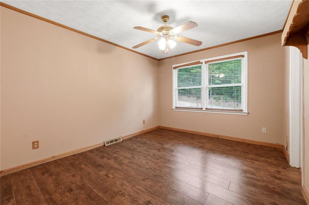 399 Donahoo Road Southeast Silver Creek, GA 30173 - Photo 9 of 22 an empty room with wooden floor and windows