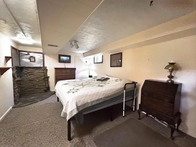 a bedroom with a bed and a chair