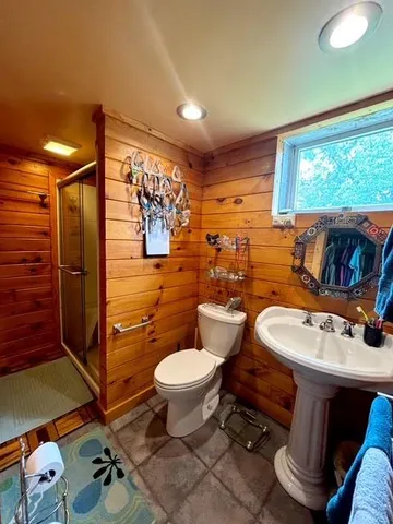 a bathroom with a glass door shower