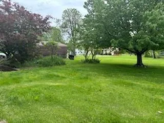 a backyard of a house with table and chairs