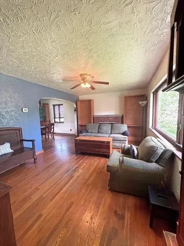 a living room with furniture and a wooden floor