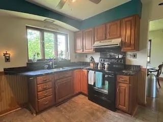 a kitchen with stainless steel appliances granite countertop a stove a sink dishwasher and a refrigerator