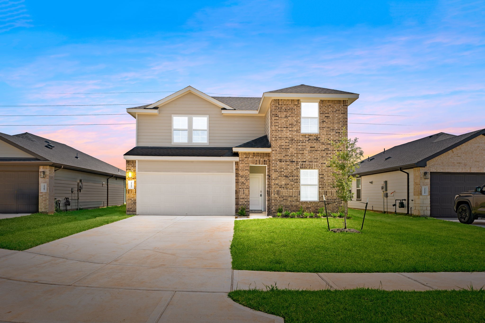 a front view of a house with a yard and garage