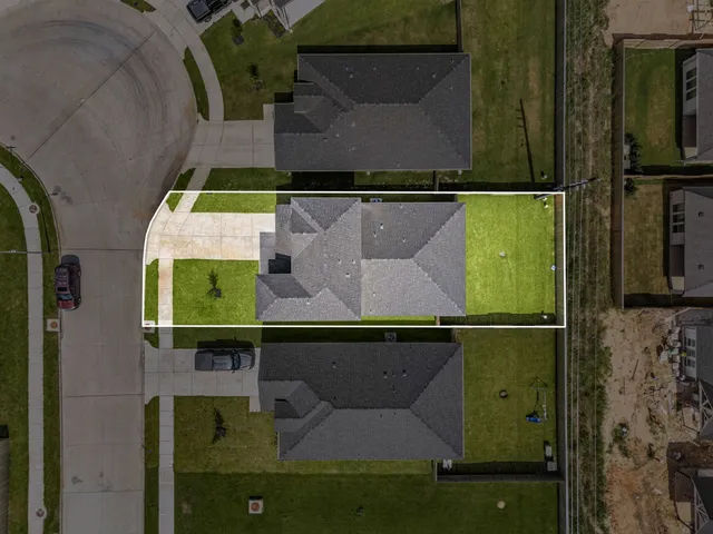 an aerial view of a house with a yard