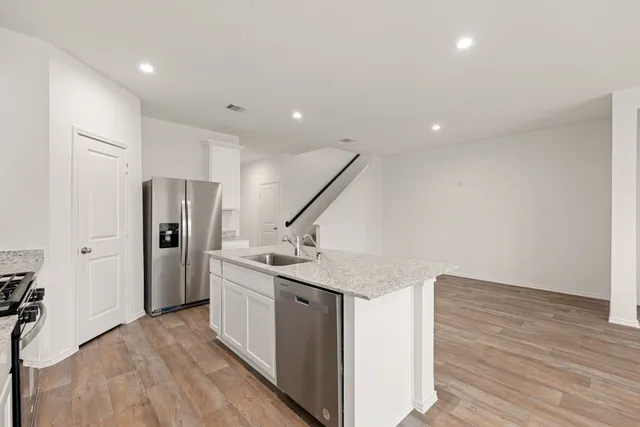 a kitchen with stainless steel appliances a refrigerator and a sink