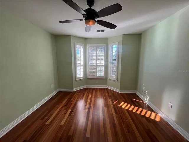 a view of a room with wooden floor
