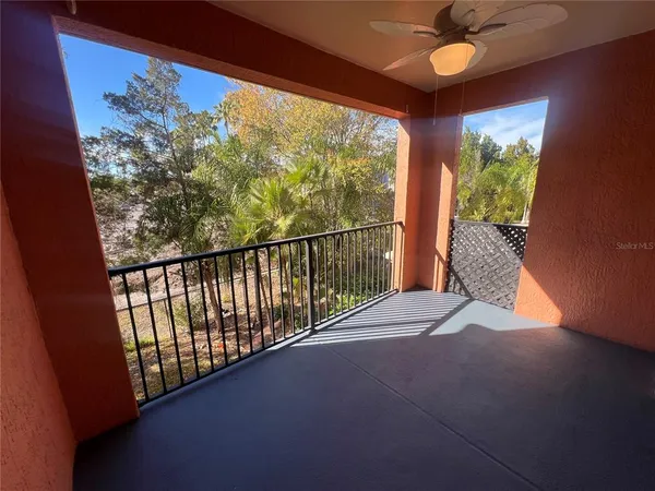 a view of balcony and ceiling fan