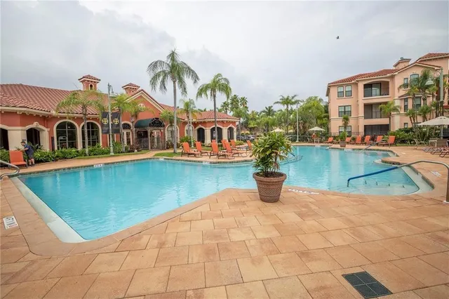a living room with fireplace furniture and a rug