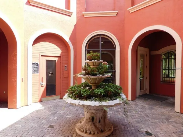 a living room with fireplace furniture and a rug