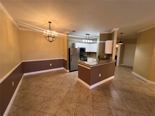a kitchen with stainless steel appliances granite countertop a refrigerator and a stove