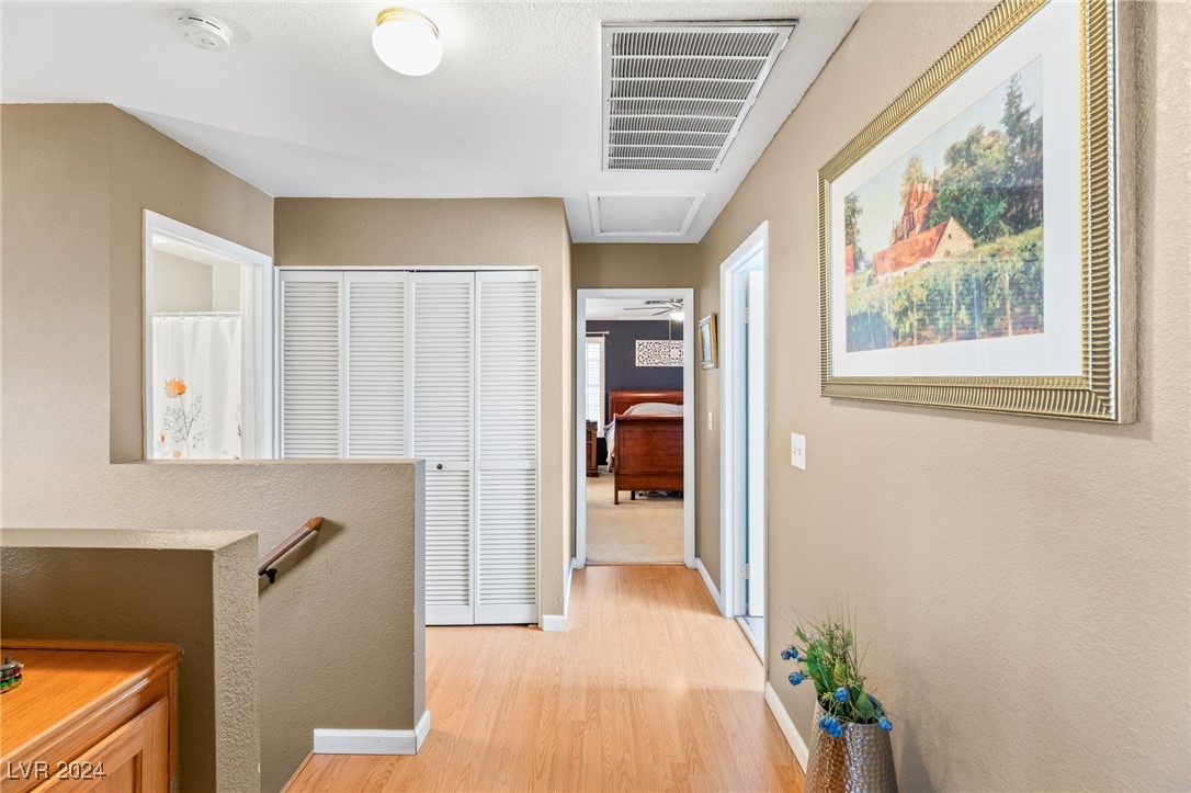 2316 Loggerhead Road Las Vegas, NV 89117 - Photo 21 of 35 Upstairs Hallway Showing Bi-fold Doors for Laundry Area