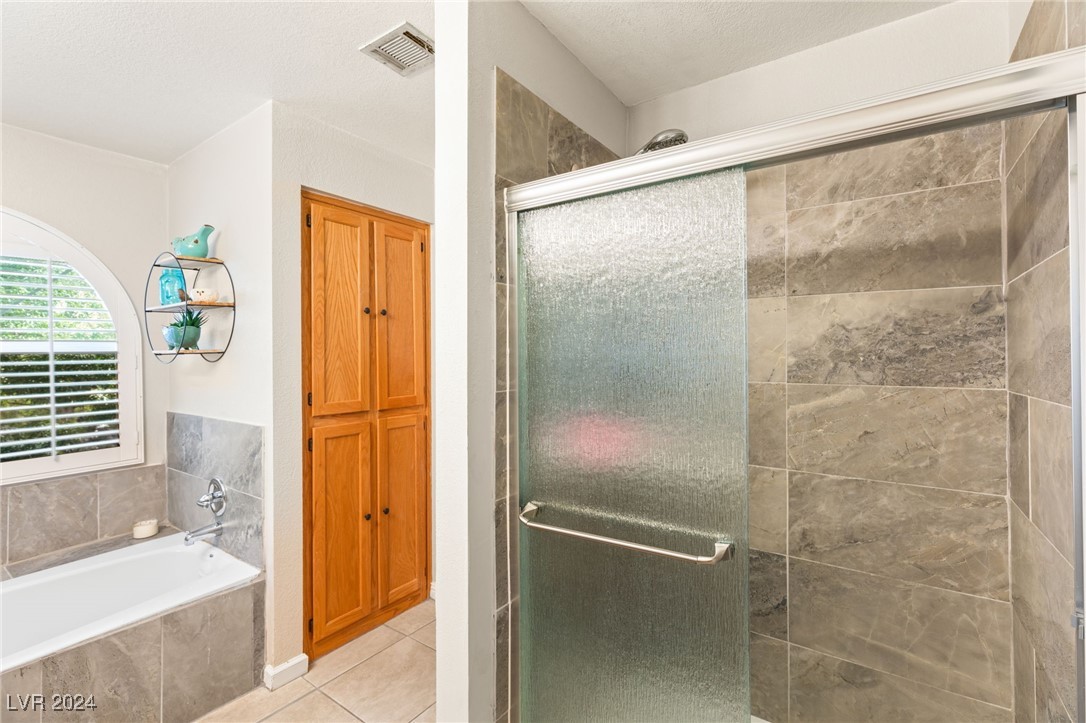 2316 Loggerhead Road Las Vegas, NV 89117 - Photo 27 of 35 Primary Tub and Shower with Updated Tile