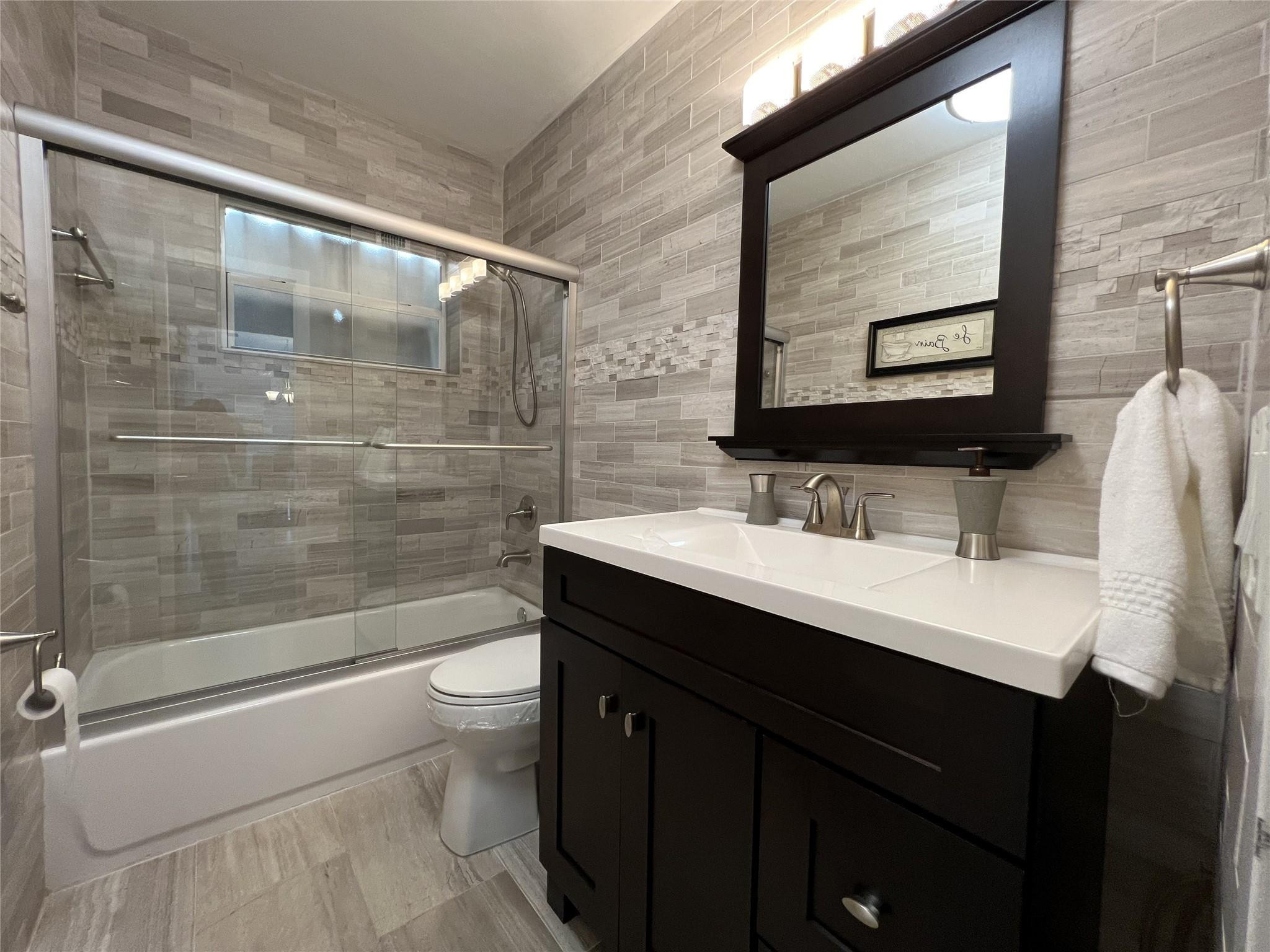 999 North Riverside Drive, Unit 9 Pompano Beach, FL 33062 - Photo 10 of 11 a bathroom with a sink shower and a toilet