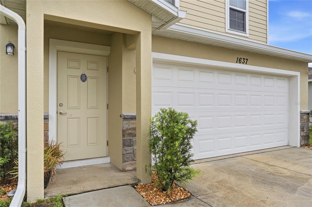 1637 Marble Street Sebring, FL 33870 - Photo 15 of 57 a potted plant in front of a door